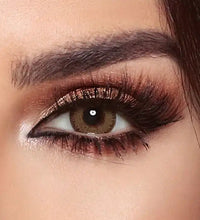 Close-up of a woman's eye with makeup, including eyeliner and mascara. Bella Glow Glow Radiant Hazelnut.