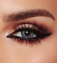 Close-up of a person's eye with dramatic makeup. Bella Glow Radiant Grey.