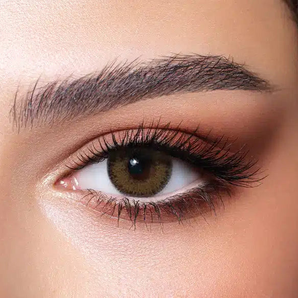 Close-up of a brown eye with detailed makeup. Bella Glow Glow Radiant Hazelnut.