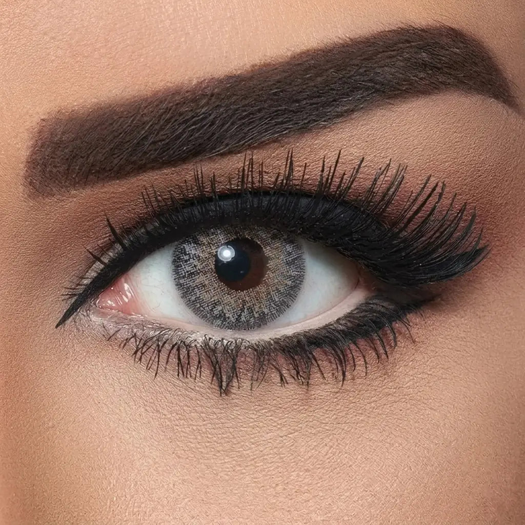 Close-up of a woman's eye with makeup, including eyelashes and eyeliner. Bella Natural Cool Grey.