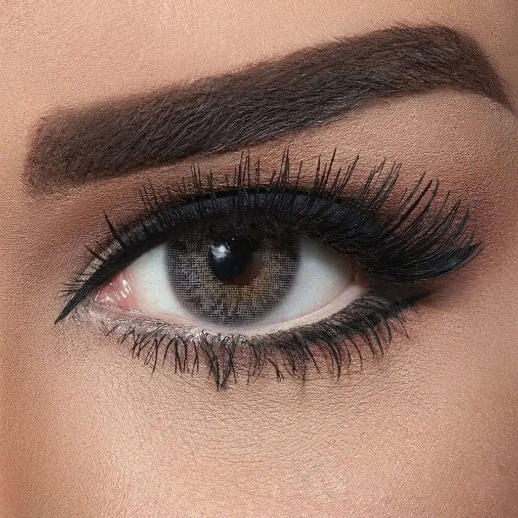 Close-up of a woman's eye with makeup, including eyeliner and mascara. Bella Natural Grey