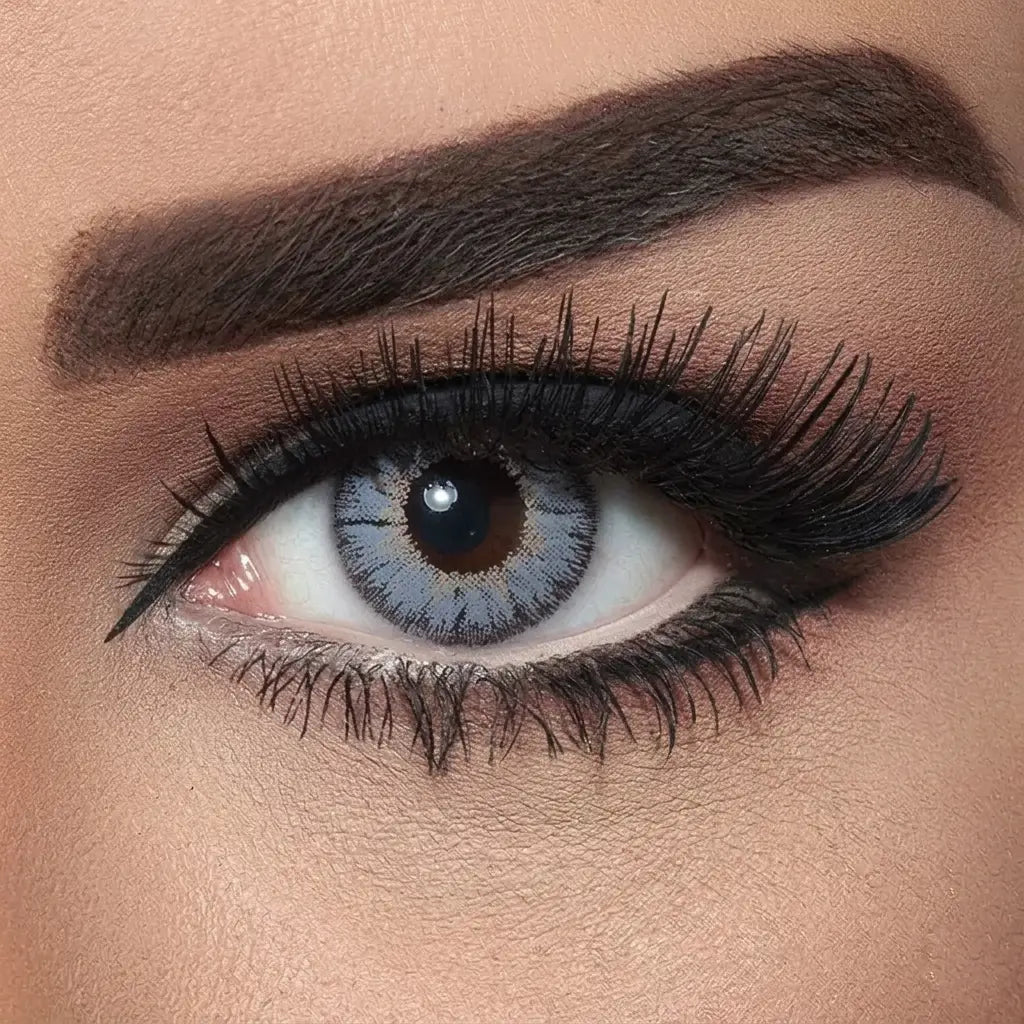 Close-up of a woman's eye with makeup, including eyeliner and mascara. Bella Natural Viola Grey