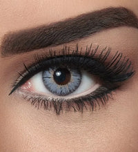 Close-up of a woman's eye with makeup, including eyeliner and mascara. Bella Natural Viola Grey