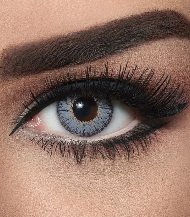 Close-up of a woman's eye with makeup, including eyeliner and mascara. Bella Natural Viola Grey