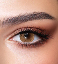Close-up of a brown eye with detailed makeup. Bella One Day Hazel Beige.