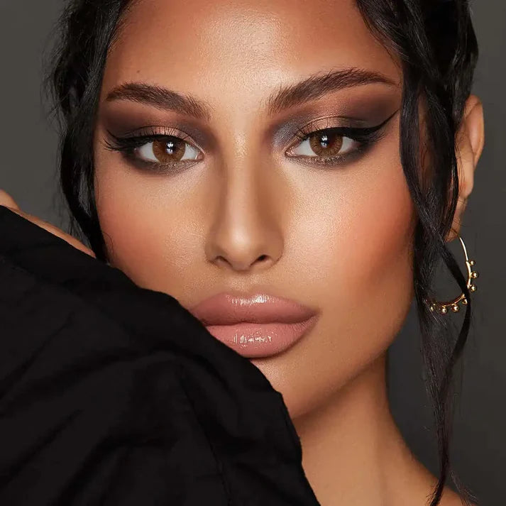Close-up of a woman with makeup and a black garment. Bella One Day Hazel Honey