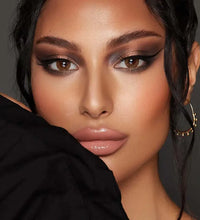 Close-up of a woman with makeup and a black garment. Bella One Day Hazel Honey