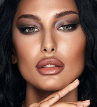 Close-up of a woman with makeup and dark hair. Bella One Day Ocean Blue